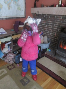 It's been so cold that the kids are wearing their ski goggles to play outside in the yard.