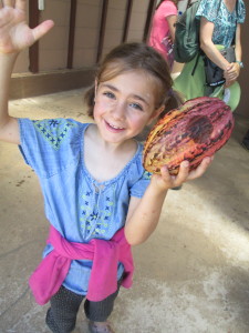 Lanie shows off a cocoa pod.