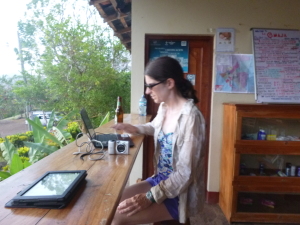 Jen copies photos onto the mini-book.  Kindle is in foreground; Tonya is in the background.