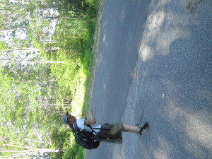 Jen slinks away from the golf course.  Note the open gate across the street.